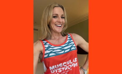 Selfie of Gabby Logan smiling, she is wearing a Team MDUK running jersey