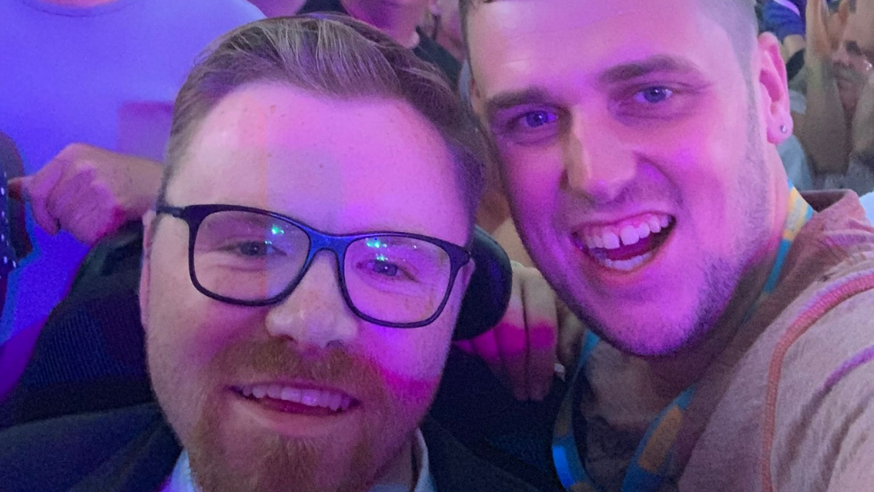 two men on a night out smile in a selfie