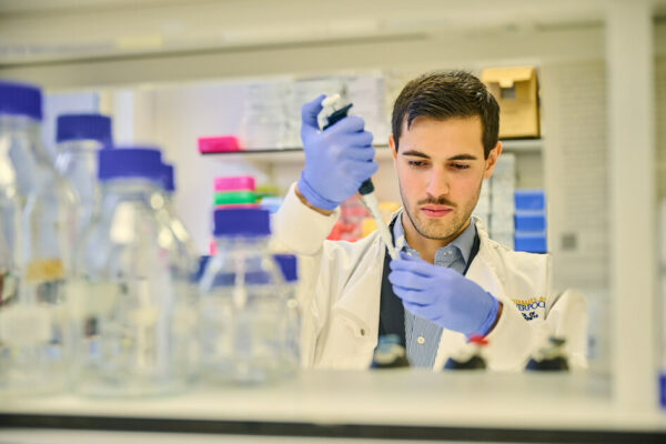 A scientists holds a test tube in a lab