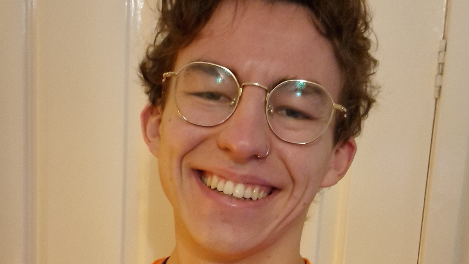 A smiling man poses for the camera