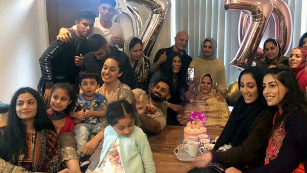 A happy crowd of friends celebrate a birthday
