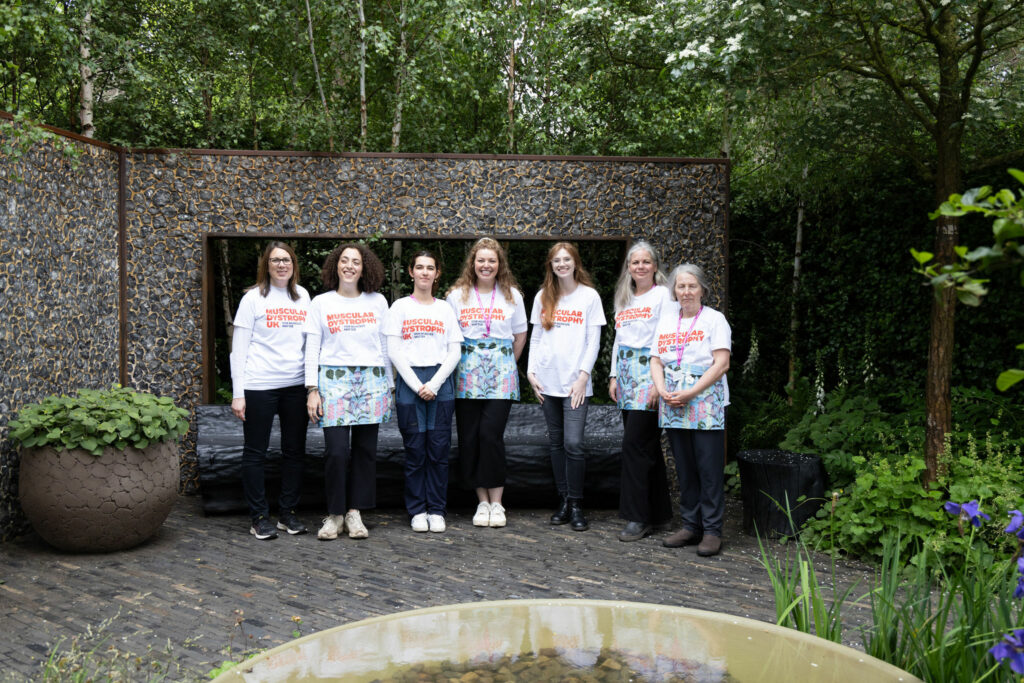 Seven women in MDUK T-Shirts at the MDUK garden at Chelsea Flower Show