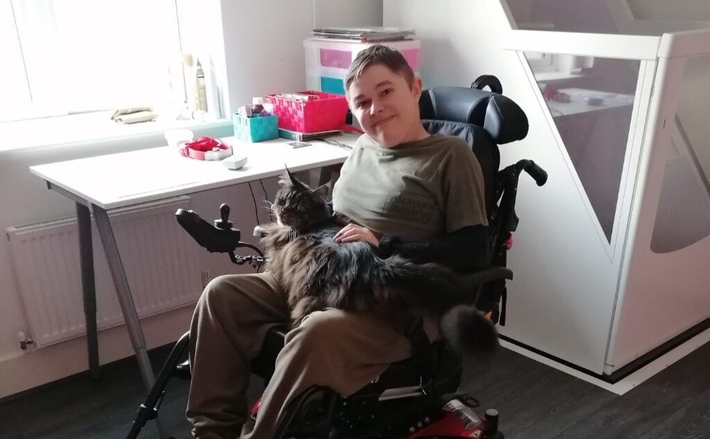A boy in a wheelchair in a new room