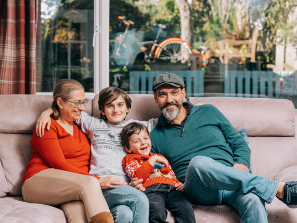 A family on a sofa hugging