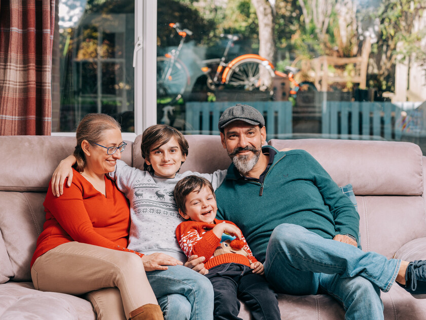 A family on a sofa hugging