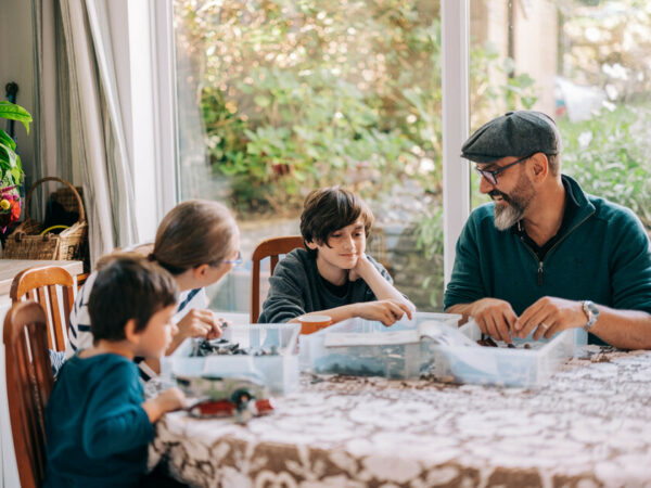 A father with three children at a table