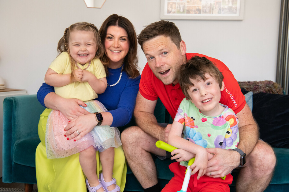 A family wearing bright clothing