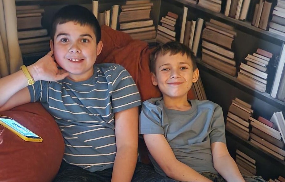Two boy in t-shirts sitting on a bean bag