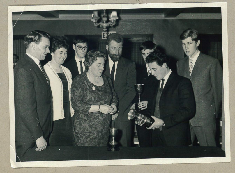 Mick Swales receiving a cycling award. It is a black and white photo