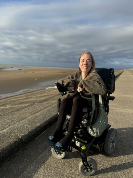 A lady in a wheelchair on a beach