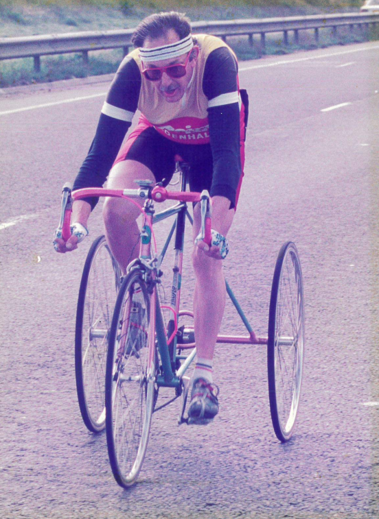 A colour photo of Mick on a bike with three wheels