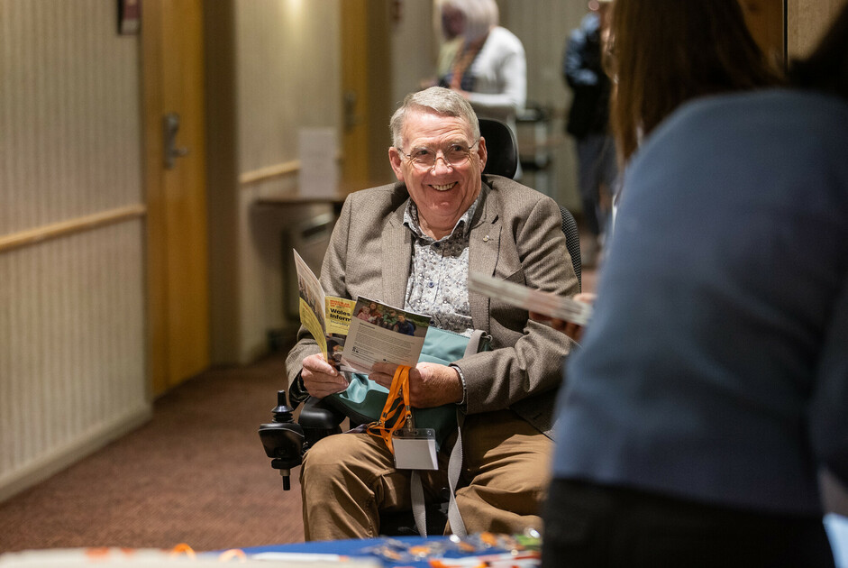 Stewart sitting in a wheechair smiling
