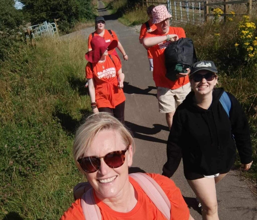 A selfie with four people walking