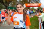 A runner poses with their medal after finishing the Cambridge 10k.