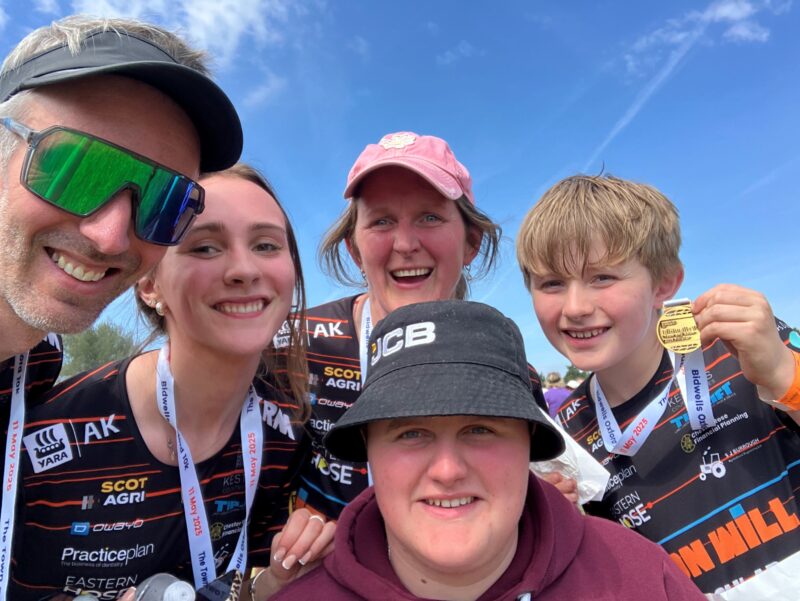 A family smile at the camera
