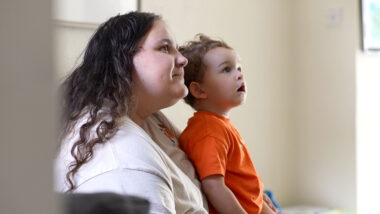 A mother and son look off into the distance together