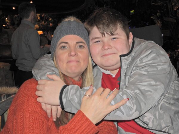 A mum and her son pose for a picture
