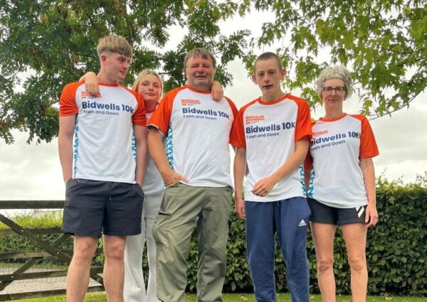 A group of people pose for a photo in muscular dystrophy uk tops