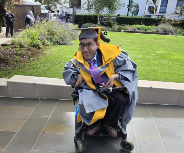 A picture of a man in a wheelchair on the street
