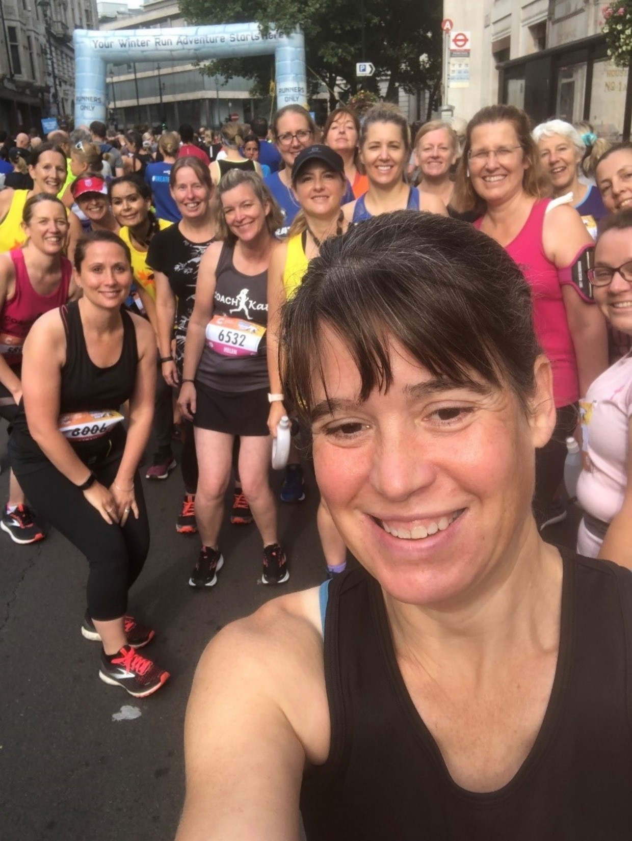 A selfie of a group of runners during a road running race