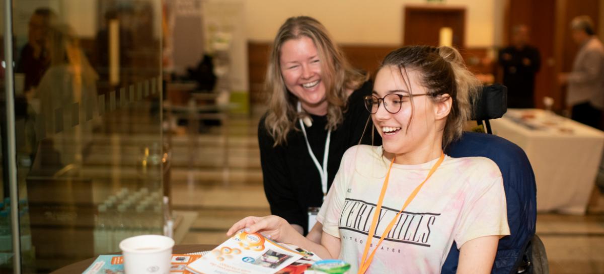 Two delegates share laughing together in the coffee break at the Muscular Dystrophy UK 2019 conference