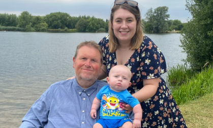 Charlotte is by a lake with her dad and son