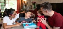 The Wilson family sat in their living room playing with their son Aadi who has SMA Type 2