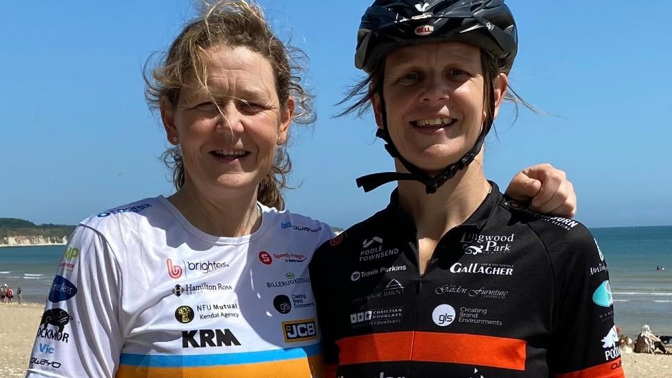 Two sisters dressed in cycling gear fundraising for Muscular Dystrophy UK